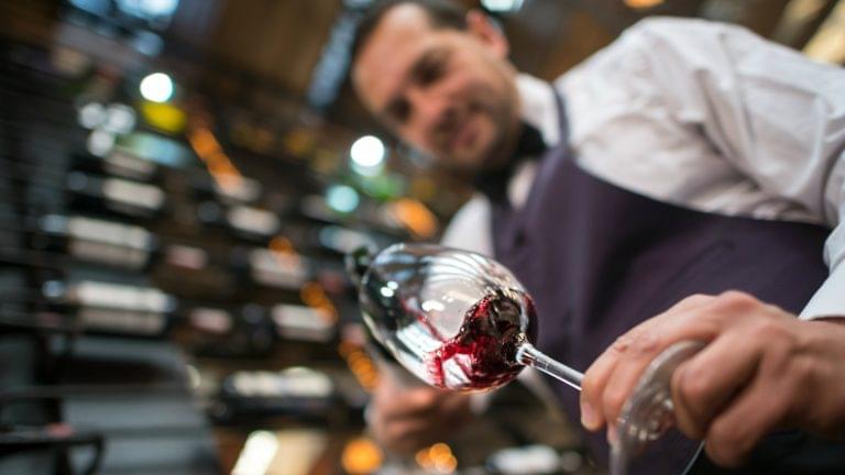 sommelier pouring wine