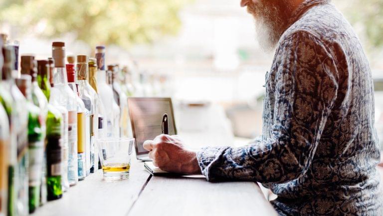 Man taking notes at a bar