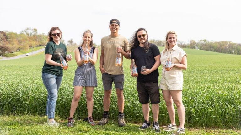 Employees of DB pose with a Wayvine producer with their limited label bottles