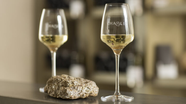 Two glasses of chablis in the foreground