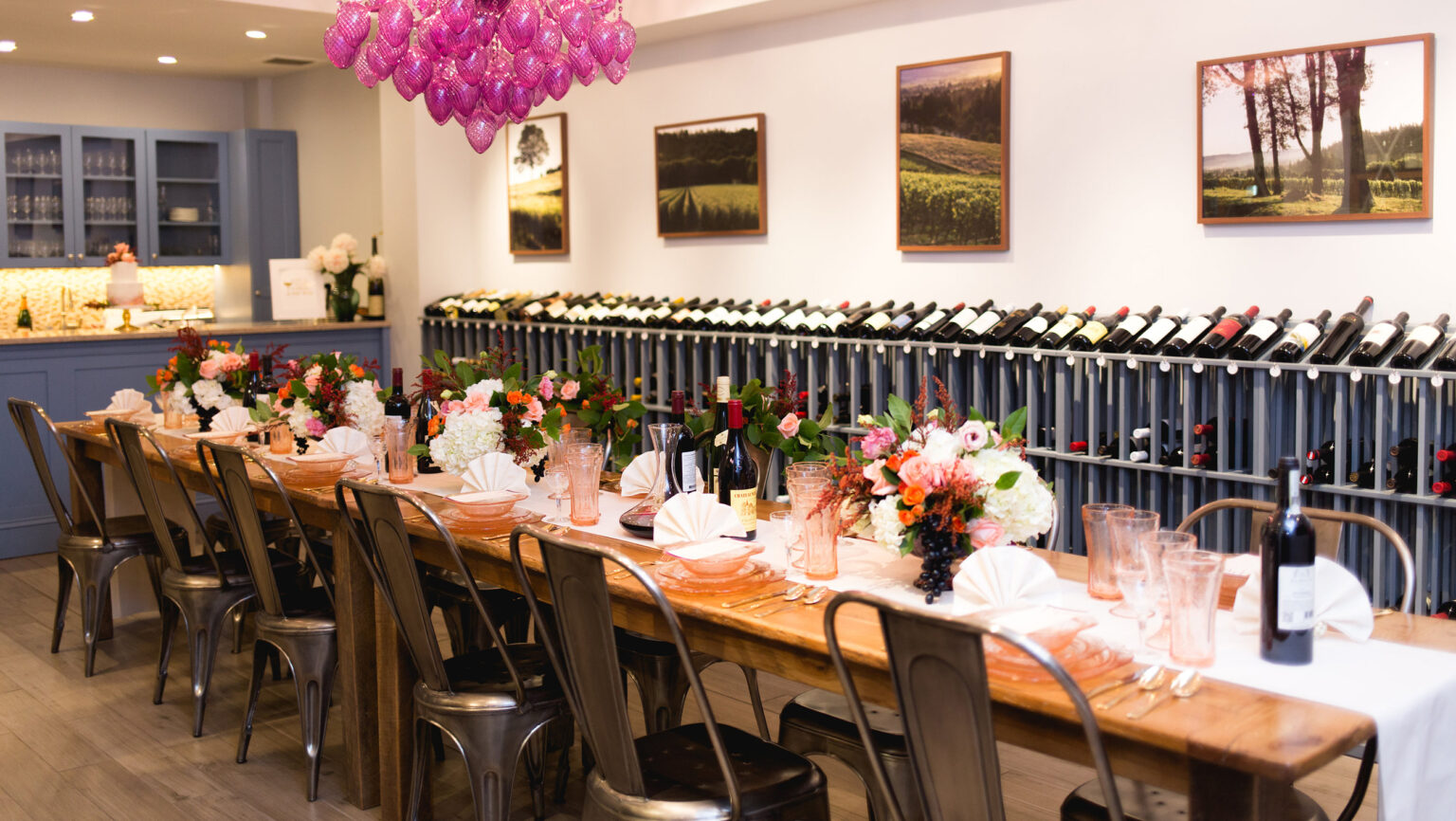 A long table set with wine bottles, presumably structured for a private event