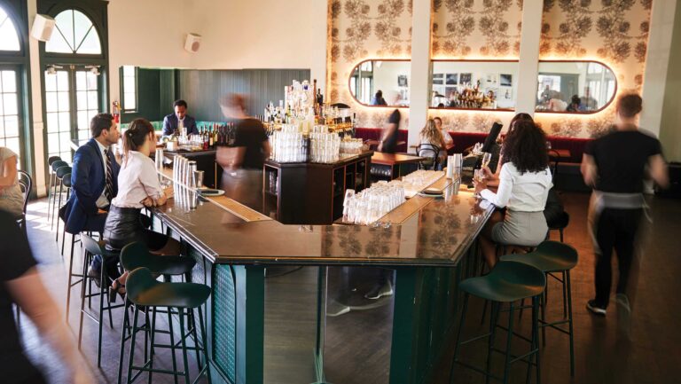 A busy bar scene, with customers moving in and out of the area in motion blurs